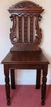 20th century carved and piercework decorated hall chair. Approx. 102cms H reasonable used