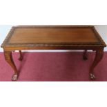 20th century carved mahogany pie crust edged coffee table on ball and claw supports. Approx. 44 x 87