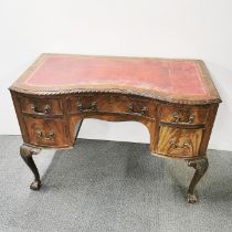 A five drawer leather topped knee hole desk with ball and claw feet, 110 x 77 x 55cm.