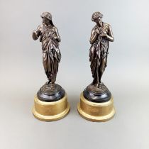 A pair of early 20th century bronze figures in classical style mounted on giltwood bases, H. 42cm.