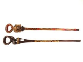 Two carved African wooden walking sticks, L. 93cm.