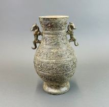 A Chinese archaic form bronze vessel with dragon handles, H.27cm.