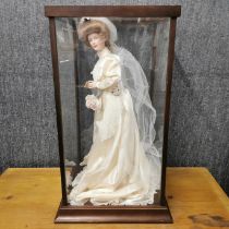 A Franklin Mint porcelain bride doll in a perspex case, case 64 x 34 x 34cm.