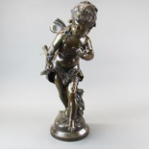 A large patinated bronze figure of a cherub with a bird, H. 69cm.
