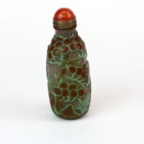 A Chinese carved Peking glass snuff bottle. With polished agate stopper, H. 9cm.