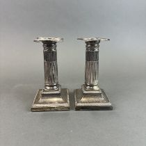 A pair of small hallmarked silver column candle sticks, H. 15cm.