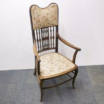 An early 20th C mahogany hall chair with inlay to carved back panel and floral upholstery, H.