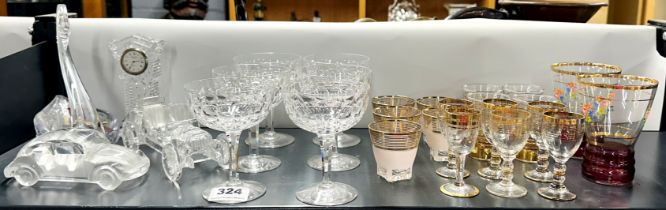 Six Stuart crystal champagne glasses and other glassware.