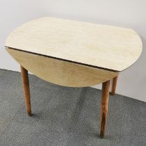A mid century 'birdseye maple' effect Formica drop leaf kitchen table, extended 101 x 101 x 76cm.
