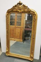 A heavy gilt wood and gesso wall mirror, 159 x 88cm.