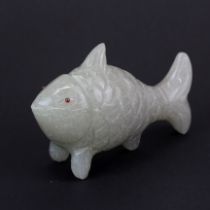 A Chinese carved serpantine model of a fish with ruby eyes, L. 10.5cm.