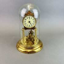A torsion gilt brass clock under dome, H. 28cm.