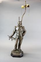 A large patinated bronze figure of a soldier mounted as a lamp base. Figure H. 67cm , Lamp H. 69cm.