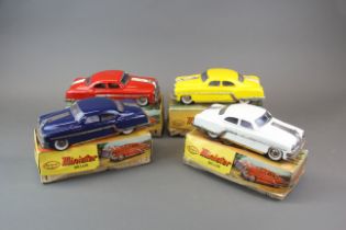 Four boxed and mechanical tin toy cars, L. 23cm.