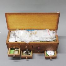A small chest of mixed watches and watch parts.