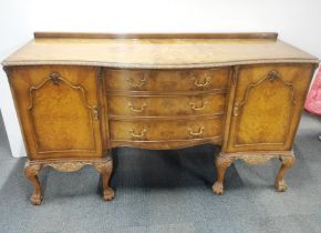 A carved and burr walnut veneered bow fronted sideboard with ball and claw feet, 170 x 95 x 58cm.