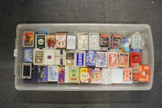 A large collection of vintage packs of playing cards.