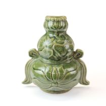 A Chinese Ming dynasty green glazed pottery wall pocket, H. 21.5cm.