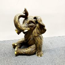 An amusing large resin figure of a young elephant, H. 57cm.
