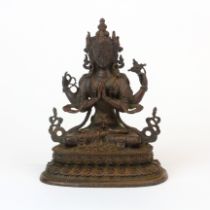 A Sino-Tibetan cast bronze figure of a four armed female deity, H. 10cm.