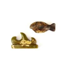 A Chinese carved hardstone fish amulet, L. 8cm. Together with a carved hardstone brush rest.