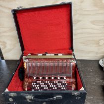 A cased vintage piano accordion.