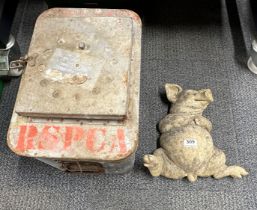 A vintage zinc animal carrier and a garden figure of a pig.