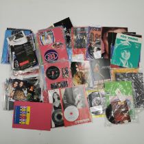 A mixed collection of rock and pop records, CDs, photographs, books, badges etc.