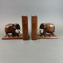 A pair of carved teak bookends each with hidden compartment, H. 17cm