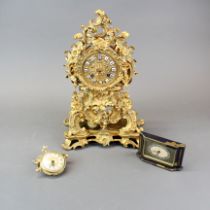 A 19thC French gilt brass mantle clock with enamelled ceramic numerals, H. 33cm. Together with two