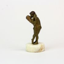 A small early 20thC cold painted bronze figure of a young couple on a marble base (base slightly a/