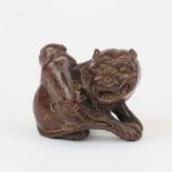 A Japenese carved fruitwood figure of a Tiger and Cub with inset mother of pearl signature, H. 3.5