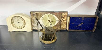 A cream Bakelite mantle clock with two vintage brass mantle clocks and a 19th century Belgian