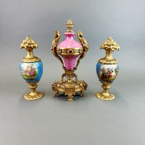 A 19th century French Ormulu mounted porcelain centre piece with a similar pair of garnitures (