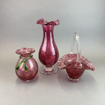 Three large pieces of cranberry glass, tallest is H.33cm