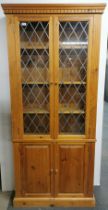 A pine display cabinet with two cupboard doors underneath, 200 x 84 x 20cm.