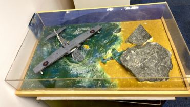 A perspex cased handmade model of a Catalina rescuing a pilot of a downed aircraft. Case size is