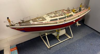 A large handmade working model of a racing yacht with stand, L. 142cm. (slight damage to hand