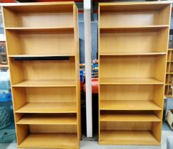 A pair of large teak effect bookshelves, 220 x 100 x 39cm.