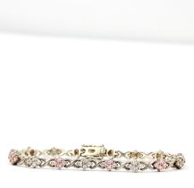 A hallmarked silver bracelet set with pink and white topaz, L. 19cm.