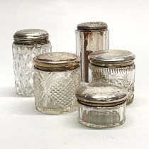 A group of five silver topped cut glass dressing table bottles, tallest H. 11.5cm.