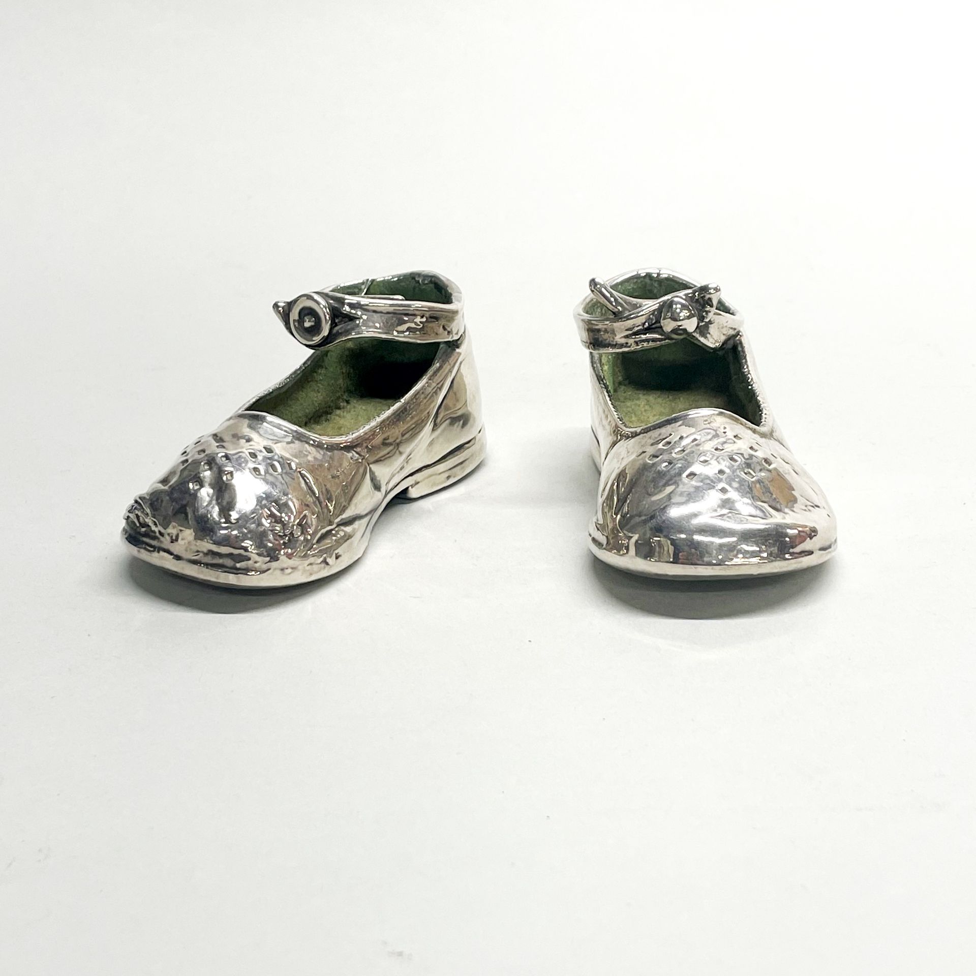 A pair of silver coated child's shoes, L.12cm