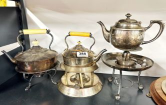 Three silver plated spirit kettles.
