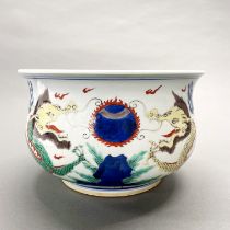 An early to mid 20th C Chinese hand painted porcelain bowl decorated with dragons, Dia. 25cm.