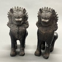 A pair of Burmese bronzed plaster lions, H. 28cm.