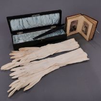 An ebony glove box and contents with a small Victorian photograph album.