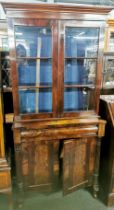 A Victorian mahogany bookcase with flame mahogany veneered doors, 195 x 92 x 40cm.