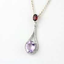 A 925 silver pendant set with a large oval cut pink amethyst and tourmaline, L. 4.5cm, on a 925