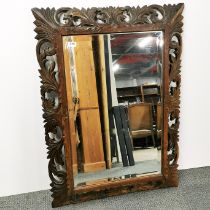 A carved oak wall mirror, 110 x 80cm.