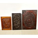 A group of four carved wooden panels, largest 50 x 70cm.